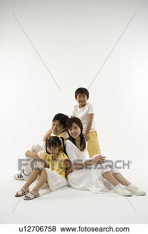 Stock Photo - Portrait of family smiling. Fotosearch