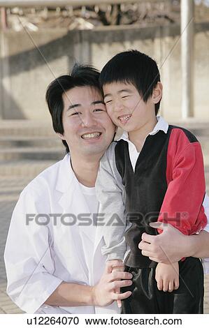 Stock Image - Portrait of father and son. Fotosearch