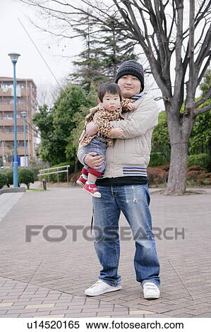 Portrait of father carrying son View Large Photo Image Stock Photography - Portrait of father carrying son. Fotosearch