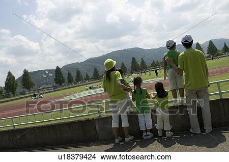 Rear view of family standing View Large Photo Image Picture - Rear view of family standing. Fotosearch