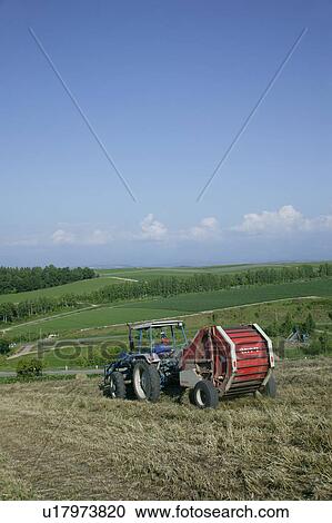 Stock Image - A farmer working in field. Fotosearch