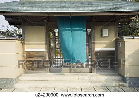 Stock Image - Cloth hanging outside lattice door. Fotosearch