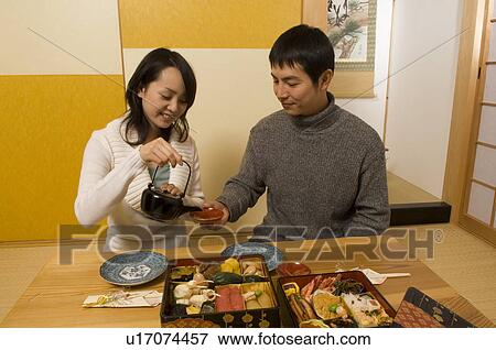 Stock Photo - Couple having New Year's Day meal. Fotosearch