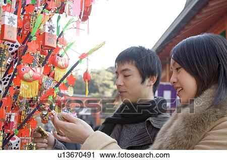 Stock Image - Couple looking at ornaments. Fotosearch