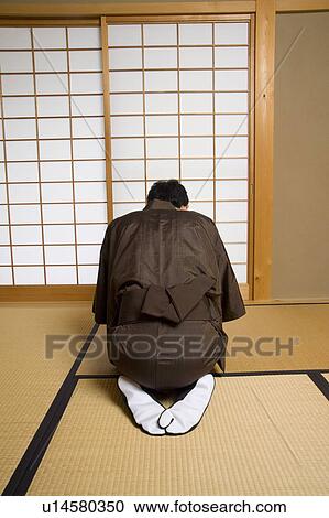 Stock Image - Man bowing, rear View. Fotosearch