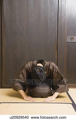 Stock Image - Man bowing. Fotosearch