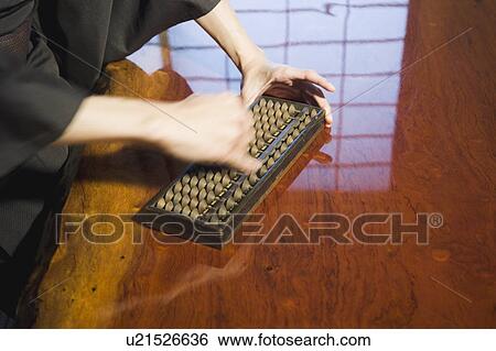 Man calculating with abacus View Large Photo Image Stock Photograph - Man calculating with abacus. Fotosearch