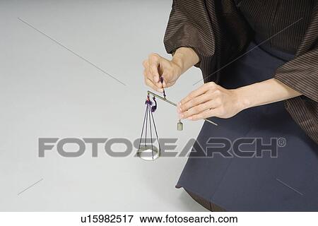 Man using balance scale View Large Photo Image Stock Photo - Man using balance scale. Fotosearch