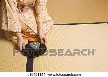Woman serving cup of tea View Large Photo Image Picture - Woman serving cup of tea. Fotosearch