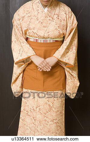 Stock Image - Woman wearing kimono with apron. Fotosearch