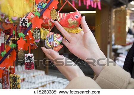 Stock Photography - Young woman holding ornaments. Fotosearch