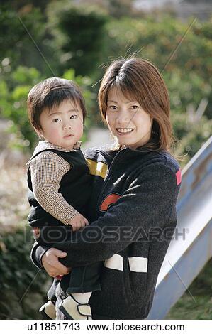Mother carrying son View Large Photo Image Stock Image - Mother carrying son. Fotosearch