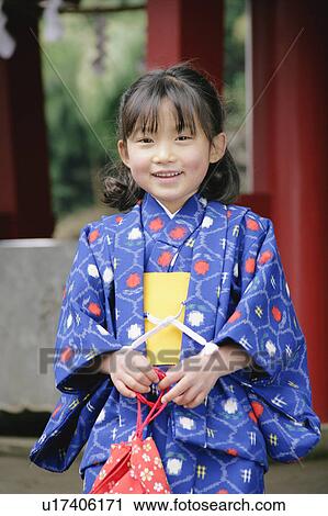 Stock Image - Portrait of a girl wearing kimono. Fotosearch