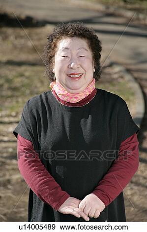 Portrait of a senior woman standing View Large Photo Image Stock Photo - Portrait of a senior woman standing. Fotosearch