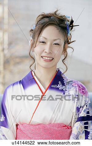 Stock Image - Portrait of a young woman wearing kimono. Fotosearch