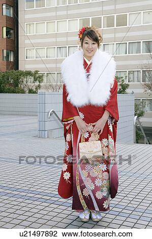 Stock Image - Portrait of a young woman wearing kimono. Fotosearch
