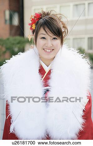 Stock Image - Portrait of a young woman wearing kimono. Fotosearch
