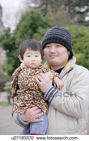 Portrait of father carrying son View Large Photo Image Stock Image - Portrait of father carrying son. Fotosearch