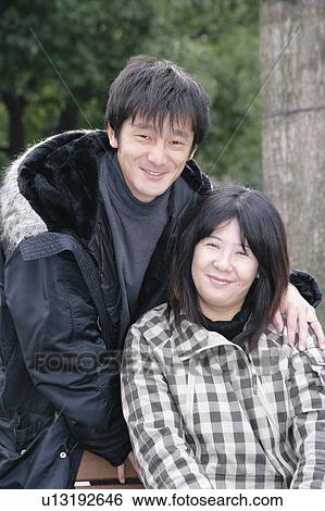 Stock Photograph - Portrait of mid adult couple. Fotosearch