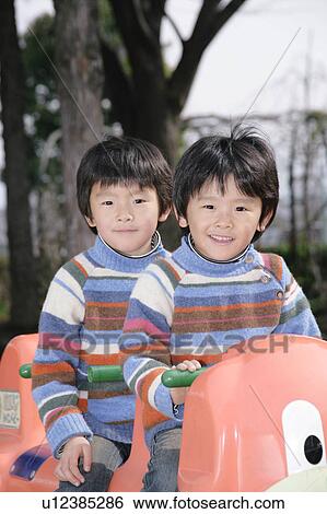 Stock Photograph - Portrait of twin brothers. Fotosearch