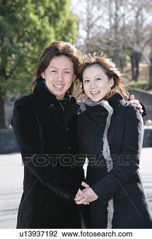 Stock Image - Portrait of young couple standing. Fotosearch