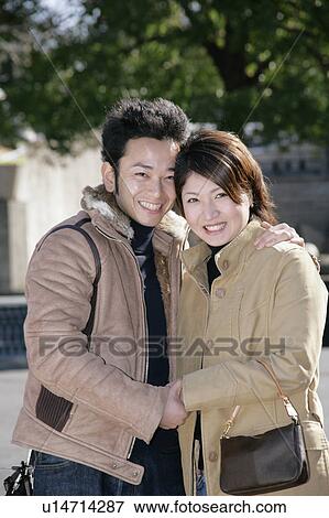 Portrait of young couple standing View Large Photo Image Stock Photo - Portrait of young couple standing. Fotosearch