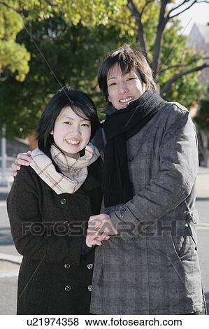 Portrait of young couple standing View Large Photo Image Stock Photo - Portrait of young couple standing. Fotosearch
