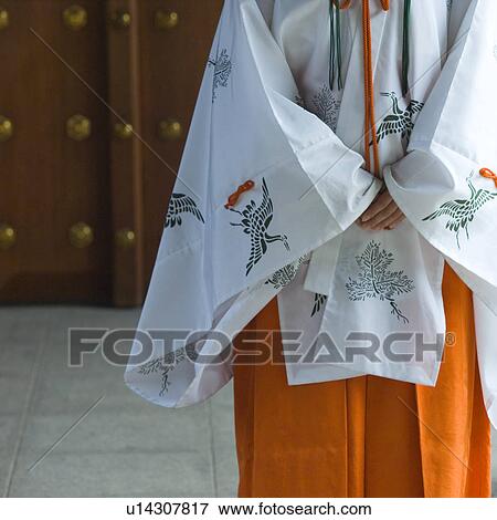 Female attendant standing at shrine View Large Photo Image Stock Photo - Female attendant standing at shrine. Fotosearch