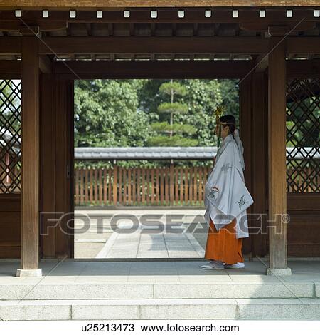 Female attendant walking at shrine View Large Photo Image Stock Image - Female attendant walking at shrine. Fotosearch