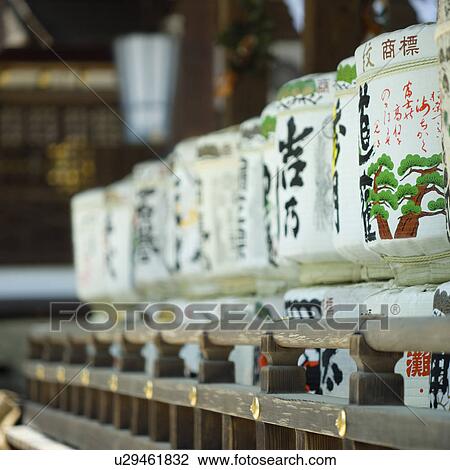 Stock Image - Sake barrels at shrine. Fotosearch