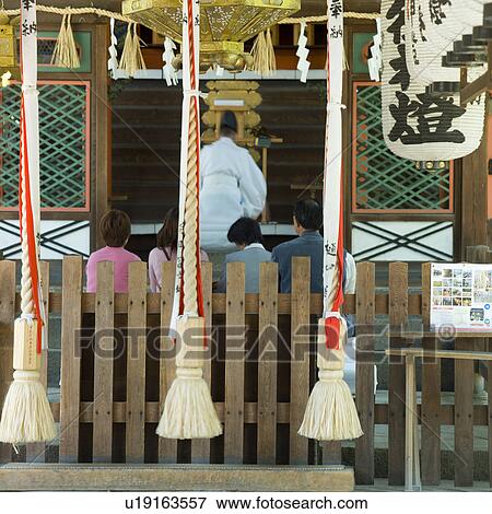Small group of people praying at shrine View Large Photo Image Stock Photo - Small group of people praying at shrine. Fotosearch