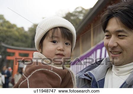 Stock Photo - Father carrying son. Fotosearch