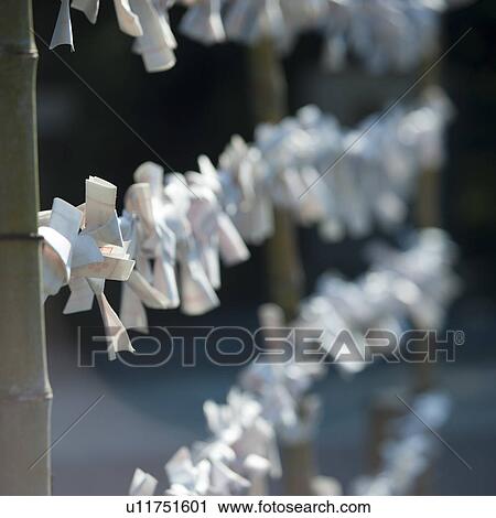 Stock Image - Fortune telling paper tied at shrine. Fotosearch