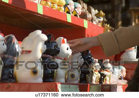 Young woman touching cat statue View Large Photo Image Stock Image - Young woman touching cat statue. Fotosearch