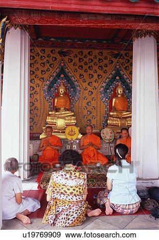 Stock Photo - People praying in a temple, Bangkok, Thailand. Fotosearch