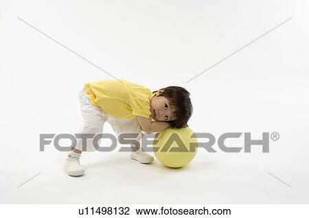 Boy playing with ball View Large Photo Image Stock Image - Boy playing with ball. Fotosearch