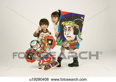 Stock Photo - Brother and sister holding kites. Fotosearch