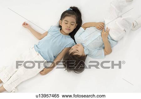 Brother and sister lying down View Large Photo Image Stock Photography - Brother and sister lying down. Fotosearch
