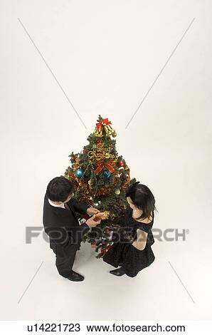 Stock Image - Couple exchanging Christmas present. Fotosearch