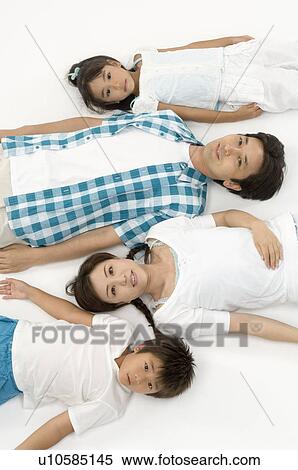 Stock Photography - Family lying down. Fotosearch