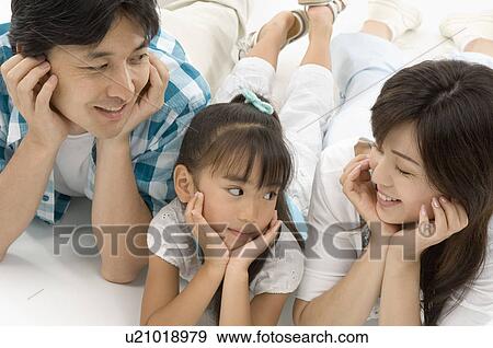 Stock Photo - Family lying on front. Fotosearch