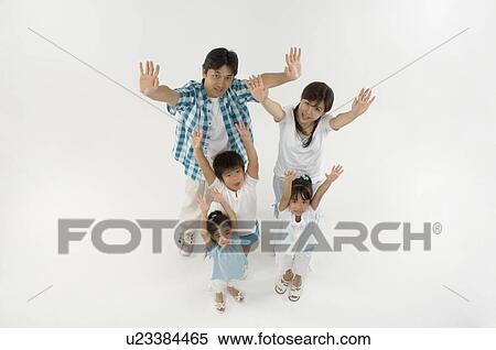 Family standing with arms raised View Large Photo Image Stock Photography - Family standing with arms raised. Fotosearch