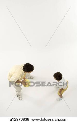 Father and son playing with ball View Large Photo Image Stock Photo - Father and son playing with ball. Fotosearch