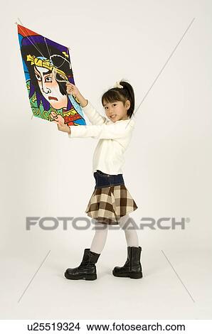 Picture - Girl holding kite. Fotosearch