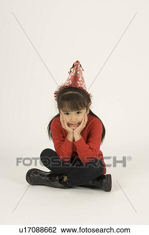 Girl sitting with her hands on her chin View Large Photo Image Stock Image - Girl sitting with her hands on her chin. Fotosearch