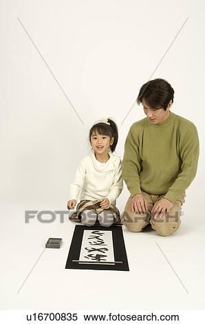 Stock Photography - Girl writing letters with ink brush. Fotosearch