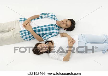 Husband and wife lying down View Large Photo Image Stock Photograph - Husband and wife lying down. Fotosearch