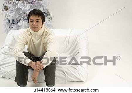 Picture - Young man spending Christmas alone. Fotosearch