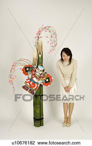 Stock Image - Young woman and New Year decoration. Fotosearch