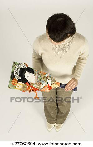 Picture - Young woman holding battledore. Fotosearch